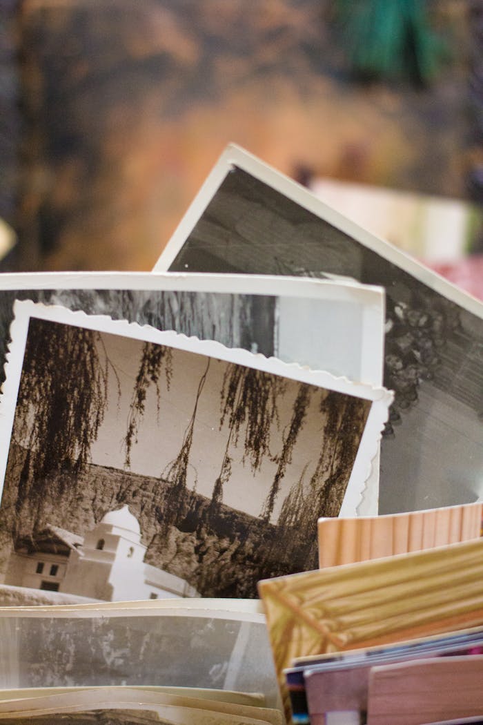 who-we-are Close-up of a stack of vintage photographs displaying historic scenes.